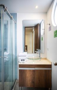 a bathroom with a sink and a glass shower at Hotel Black Usaquen in Bogot&aacute;