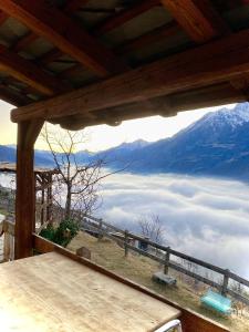 a view from the porch of a house with a mountain at La stanza dei segreti in Aosta