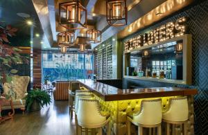 a bar with yellow chairs in a restaurant at Hotel Black Usaquen in Bogotá