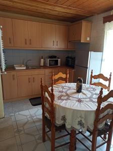 a kitchen with a table with two chairs and a tableablish at Feneos apartment in Feneos