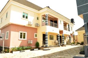 a house with pink and yellow at The Morville Suites and Apartments in Abeokuta
