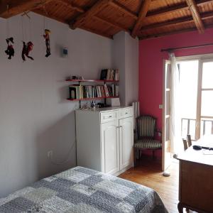 a bedroom with a bed and a table and a chair at Sunrise house Alonnisos in Alonnisos
