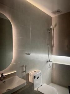a bathroom with a toilet and a sink and a shower at جده هاوس Jeddah house in Jeddah