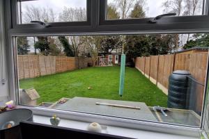 a window view of a yard with a fence at Self-contained annex, with parking. in Kent