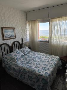 a bedroom with a bed and a window at Casa Nostrum Priceless View Central Location 3BR 3BA in Punta del Este