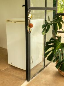 a small refrigerator next to a window with a butterfly on it at SELVA ADENTRO in Norcasia