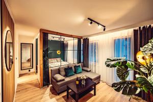 a living room with a couch and a table at Elegance Loft Apartment in Skoczów