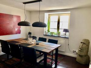 a dining room with a wooden table and chairs at Ferienhaus Eifel-Auszeit in Rieden