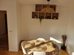 a dining room table with bowls on top of it at Appartement Enghien-les-Bains à 7 min du Casino Barrière in Enghien-les-Bains