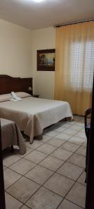 Łóżko lub łóżka w pokoju w obiekcie Hotel Colosseo Colleferro