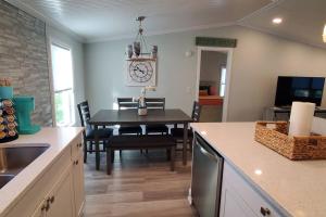a kitchen and dining room with a table and a dining room at Waterfront home with private dock, walk to beach in Saint Augustine