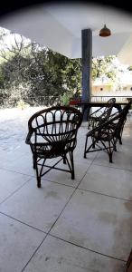 two benches sitting next to a table on a patio at RAJVILAS SUITES in Dehradun