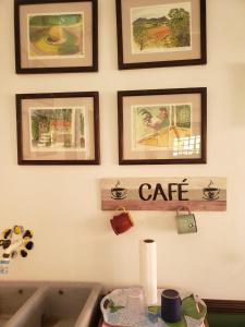 a bathroom with a sink and some pictures on the wall at SERENITY BY NATURE in Carrillos