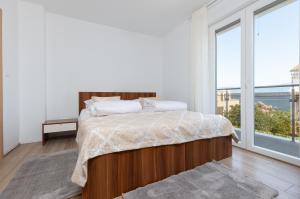 a bedroom with a bed and a large window at Luxury villa Vincent in Slatine +28 photos