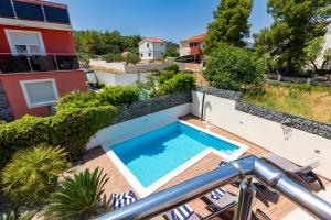 a swimming pool on a patio with a house at Luxury villa Vincent in Slatine