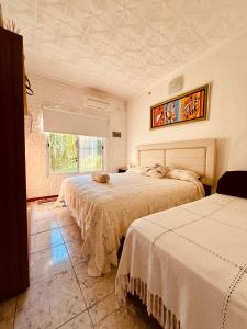 - une chambre avec 2 lits et une fenêtre dans l'établissement Casa Santa Ana Punta Teco, à Santa Ana