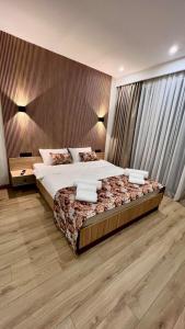 a bedroom with a large bed and a large window at Gudauri Twins 404 in Kʼumlistsʼikhe