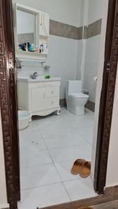 a bathroom with a sink toilet and a mirror at Patriata Luxury Suits in Murree +30 photos