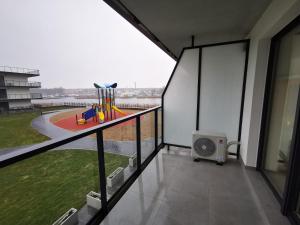 a balcony with a view of a playground at Apolonia apartament II- SPA in Dziwnów