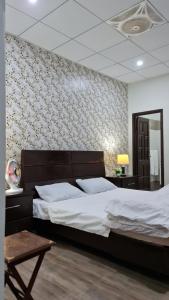 a bedroom with a large bed and a mirror at Patriata Luxury Suits in Murree