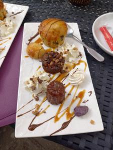 a plate of food on a table with desserts at Hotel de la Halle in Nolay