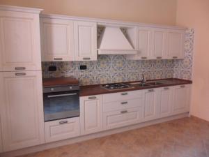 a white kitchen with white cabinets and a sink at Palazzo Gentilizio de Maffutiis in Auletta