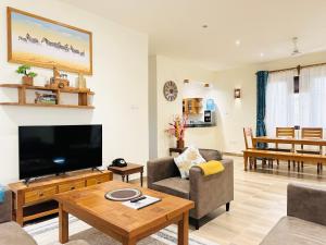 a living room with a large flat screen tv at 3 Bedroom Deluxe Villa-Mfalme in Diani in Diani Beach