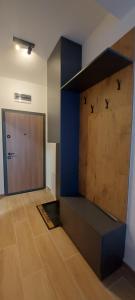 a room with a wooden door and a wall with birds on it at Apartman Mali princ Jahorina in Jahorina