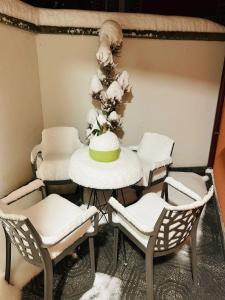 a table with chairs and a cake on top of it at Vila Alba in Korçë