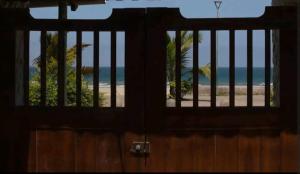 an open door with a view of the beach at Casa Mañana in Puerto López