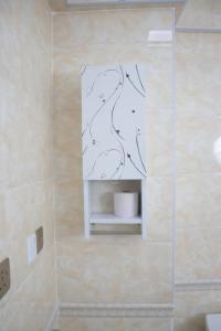 a bathroom with a shower with a drawing on the wall at 4bedroom Navilla westlands Nairobi in Nairobi