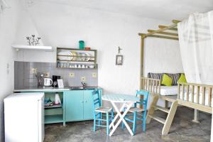 a kitchen with a table and chairs and a couch at Mantos rooms 1 in Neo Klima