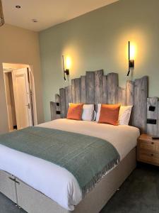a bedroom with a large bed with a wooden headboard at Balmoral Hotel in Blackpool