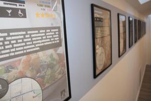 a poster on a wall with pictures on it at Design Immo Ferienwohnung Rhein-Main Rodgau in Rodgau