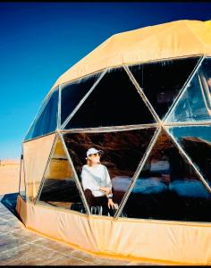 a man is sitting in the cockpit of a plane at Rum Goldeneye luxury camp in Wadi Rum