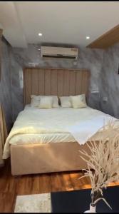 a bedroom with a large bed with white sheets and pillows at Hatta Farm caravan in Hatta
