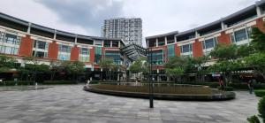 a courtyard with a fountain in front of a building at Plaza Arkadia in Desa ParkCity in Kuala Lumpur