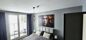 a bedroom with a bed and a large painting on the wall at Skopje Sky Oasis in Skopje +15 photos