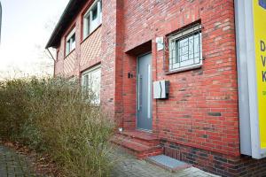 un edificio de ladrillo rojo con puerta y ventana en nobilis Apartment - 8 Pers. - Zentrumsnah - Netflix, en Meppen