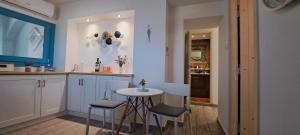 a kitchen with a small table and chairs in it at Final step in Skiathos Town