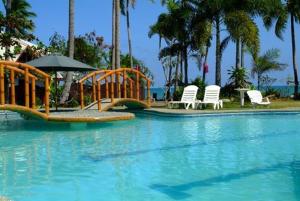 a playground in a pool with chairs and an umbrella at Crystal Paradise Resort Spa & Winery in Narra