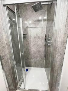 a shower with a glass door in a bathroom at Shared House in central location Inverness in Inverness