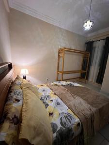 a bedroom with a large bed in a room at Residence Ethan Nji - Chic urban in Yaoundé