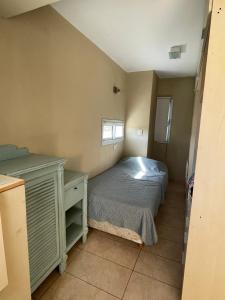 Habitación pequeña con cama y escritorio. en Rincon de Montaña in 
