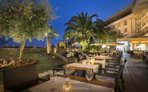 a restaurant with tables and chairs at night at Hotel Admiral - by Liburnia Hotels & Villas in Opatija