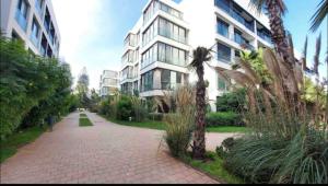 a brick sidewalk in front of a tall building at Cosy appartement à Ain Diab beach in Casablanca