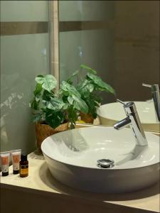 a bathroom sink with a faucet and a mirror at Cosy appartement à Ain Diab beach in Casablanca
