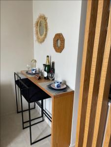 a table with two plates and a bottle of wine at Cosy appartement à Ain Diab beach in Casablanca