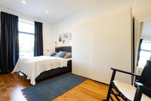 a bedroom with a bed and a large window at Exklusive Apartments in Kieler City in Kiel