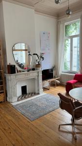 sala de estar con chimenea y espejo en Arti Appart Louise/Flagey/Centre en Bruselas